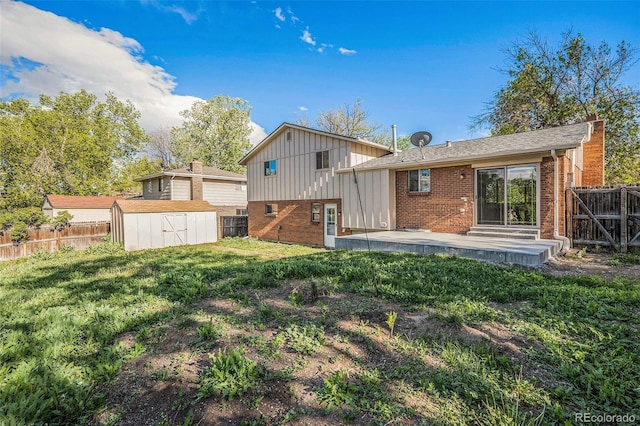 9345 W Iowa Pl, Lakewood, CO 80232 - rear view of property featuring brick siding, a chimney, a patio area, board and batten siding, and roof with shingles