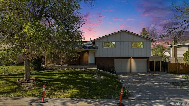 9345 W Iowa Pl, Lakewood, CO 80232 - split level home featuring brick siding, an attached garage, driveway, and board and batten siding