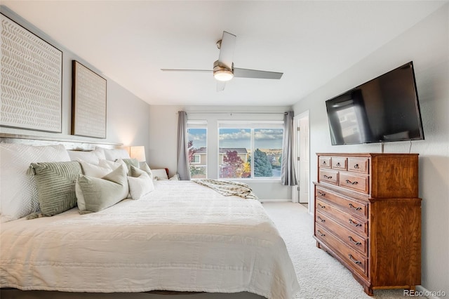 bedroom with ceiling fan and light carpet