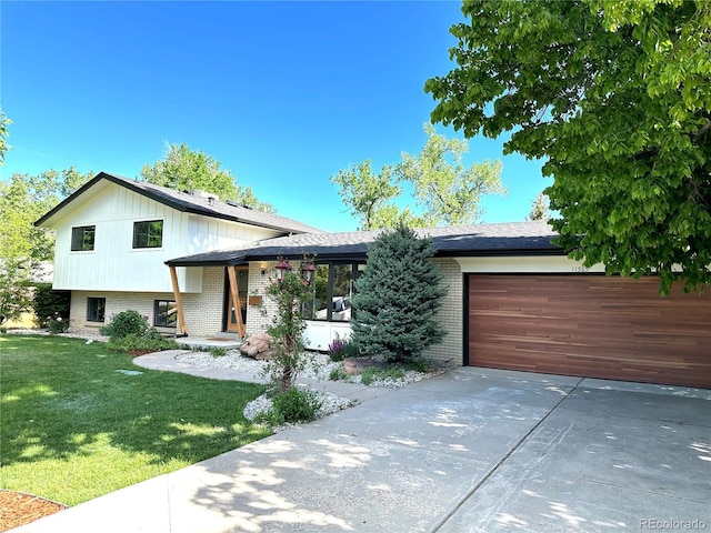 11569 W 27th Ave, Lakewood, CO 80215 - tri-level home with brick siding, driveway, an attached garage, and a front lawn