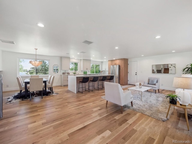 11569 W 27th Ave, Lakewood, CO 80215 - living room with light wood finished floors, recessed lighting, and baseboards