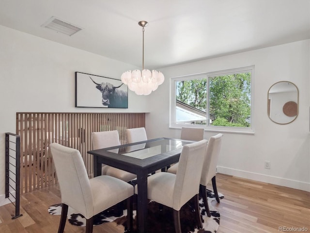 11569 W 27th Ave, Lakewood, CO 80215 - dining room featuring a chandelier, light wood finished floors, and baseboards