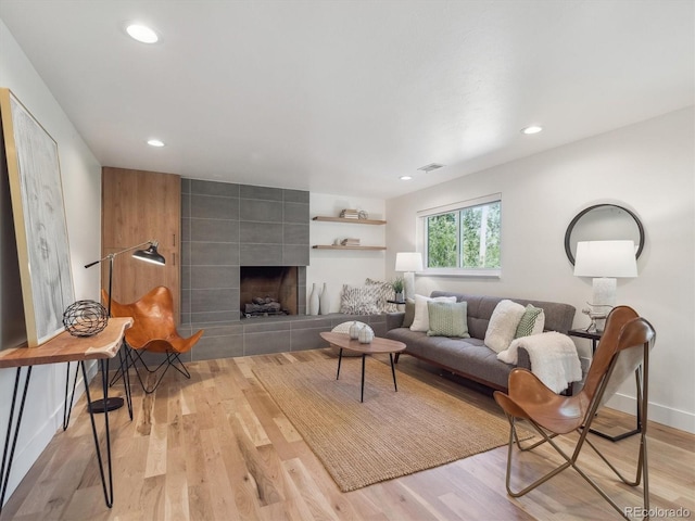 11569 W 27th Ave, Lakewood, CO 80215 - living area featuring light wood-type flooring, recessed lighting, a tiled fireplace, and baseboards