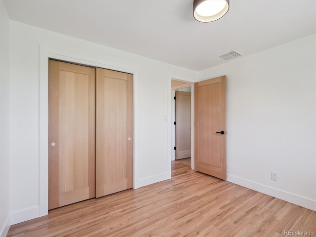 11569 W 27th Ave, Lakewood, CO 80215 - unfurnished bedroom featuring baseboards, light wood-type flooring, and a closet