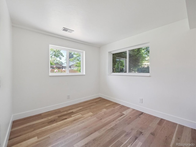11569 W 27th Ave, Lakewood, CO 80215 - empty room with baseboards and light wood-style floors