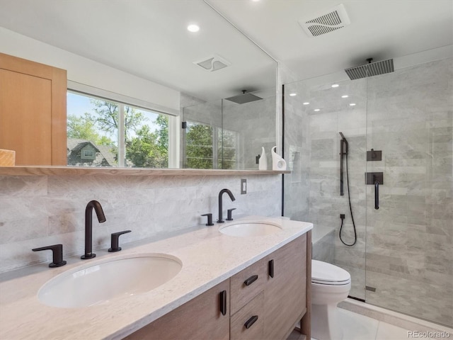 11569 W 27th Ave, Lakewood, CO 80215 - full bathroom featuring a stall shower, double vanity, backsplash, tile patterned floors, and recessed lighting