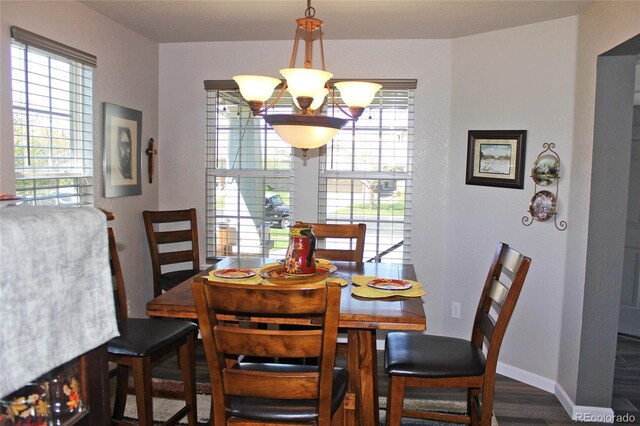 7824 S Zante Ct, Aurora, CO 80016 - dining room with wood finished floors, plenty of natural light, and a chandelier