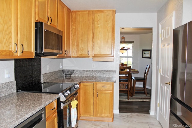 7824 S Zante Ct, Aurora, CO 80016 - kitchen featuring appliances with stainless steel finishes, light marble finish floors, stone counters, and baseboards