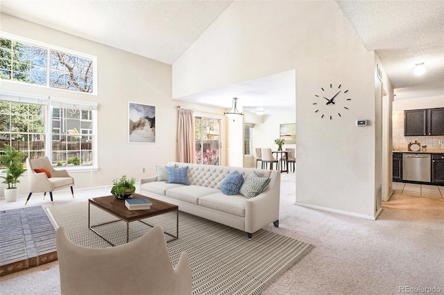 living room featuring baseboards, a textured ceiling, and a towering ceiling