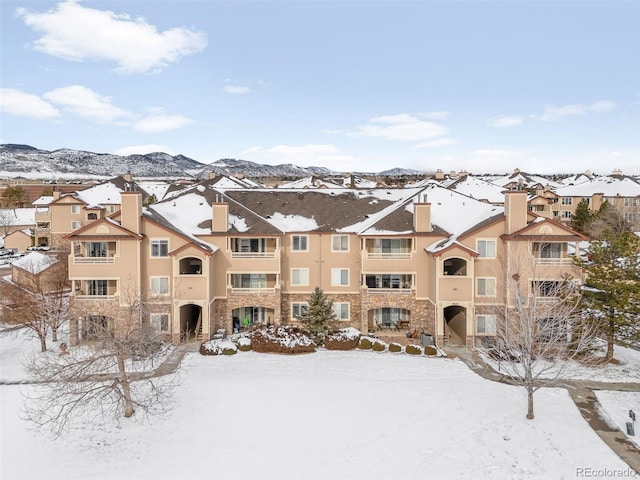 snow covered property featuring a mountain view