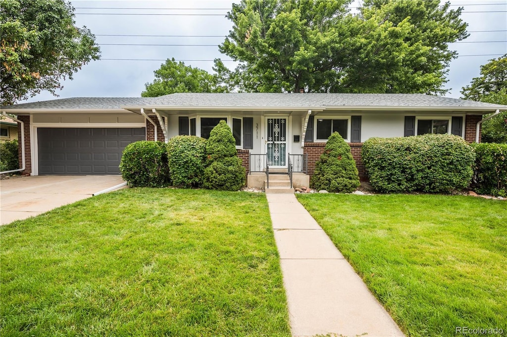 single story home featuring a garage and a front yard