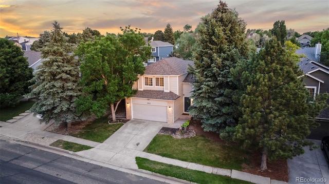 3032 Pony Tracks Dr, Colorado Springs, CO 80922 - view of front of home featuring concrete driveway, a garage, and a front lawn
