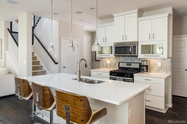 5451 W 73rd Ave, Westminster, CO 80003 - kitchen with appliances with stainless steel finishes, dark wood-style floors, decorative backsplash, and recessed lighting