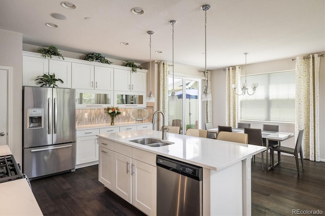 5451 W 73rd Ave, Westminster, CO 80003 - kitchen featuring stainless steel appliances, dark wood-style flooring, a chandelier, tasteful backsplash, and recessed lighting