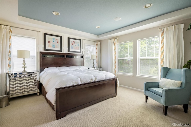 5451 W 73rd Ave, Westminster, CO 80003 - bedroom with light colored carpet, multiple windows, a tray ceiling, and recessed lighting