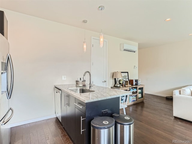 kitchen featuring sink, a wall unit AC, kitchen peninsula, and stainless steel appliances