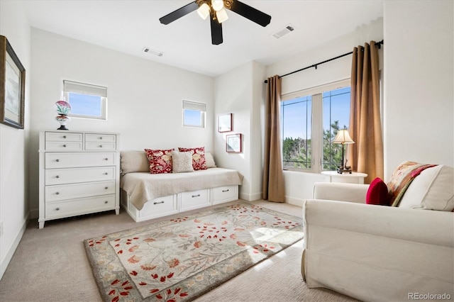 bedroom with baseboards, a ceiling fan, visible vents, and light colored carpet