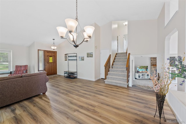 7226 S Eagles Nest Cir, Littleton, CO 80127 - living area with high vaulted ceiling, wood finished floors, stairway, baseboards, and a chandelier