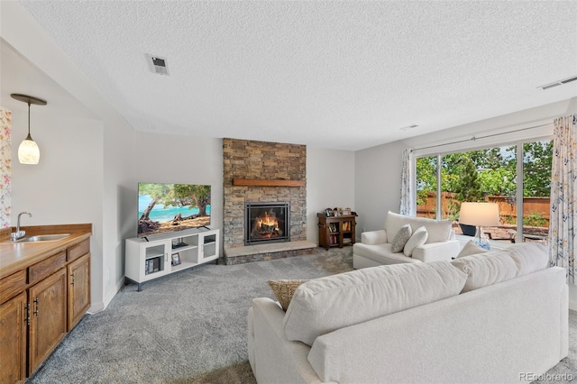 7226 S Eagles Nest Cir, Littleton, CO 80127 - living area featuring light colored carpet, a textured ceiling, a fireplace, and baseboards