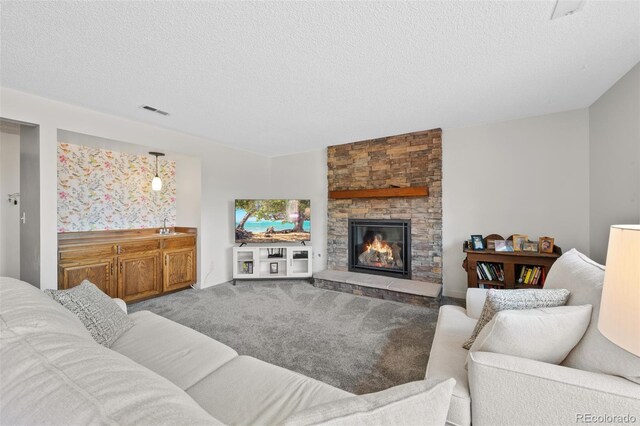 7226 S Eagles Nest Cir, Littleton, CO 80127 - living area featuring a textured ceiling, carpet floors, and a fireplace