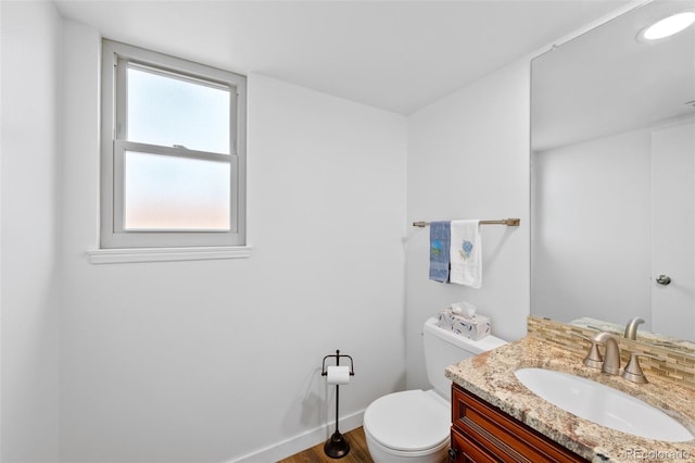 7226 S Eagles Nest Cir, Littleton, CO 80127 - bathroom featuring toilet, vanity, wood finished floors, and baseboards