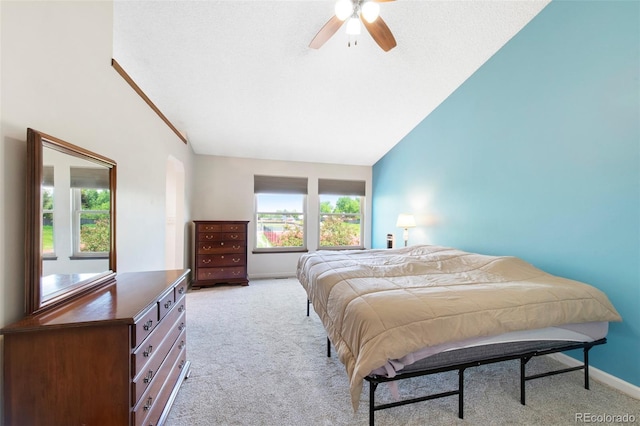 7226 S Eagles Nest Cir, Littleton, CO 80127 - bedroom with light carpet, vaulted ceiling, baseboards, and a ceiling fan