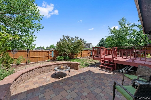 7226 S Eagles Nest Cir, Littleton, CO 80127 - fenced backyard featuring a fire pit, a deck, and a patio