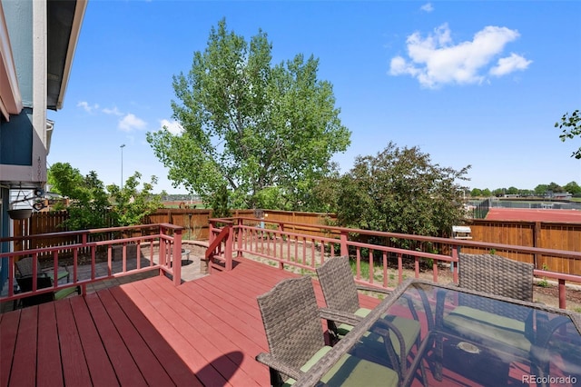 7226 S Eagles Nest Cir, Littleton, CO 80127 - wooden deck with outdoor dining area and a fenced backyard