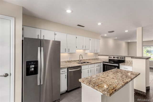 2301 E Fremont Ave Unit W08, Centennial, CO 80122 - kitchen featuring appliances with stainless steel finishes, a peninsula, white cabinets, light stone counters, and a center island