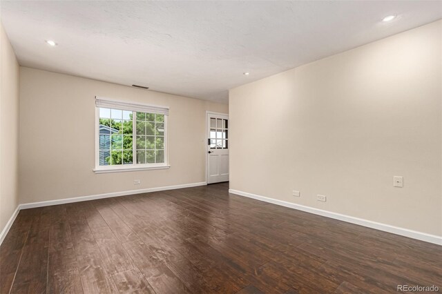 2301 E Fremont Ave Unit W08, Centennial, CO 80122 - empty room featuring dark wood-style floors and recessed lighting