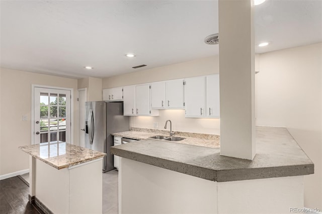 2301 E Fremont Ave Unit W08, Centennial, CO 80122 - kitchen with white cabinetry, recessed lighting, stainless steel refrigerator with ice dispenser, a kitchen island, and a peninsula