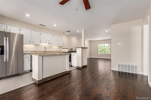 2301 E Fremont Ave Unit W08, Centennial, CO 80122 - kitchen with stainless steel appliances, dark wood-style flooring, ceiling fan, a center island, and open floor plan