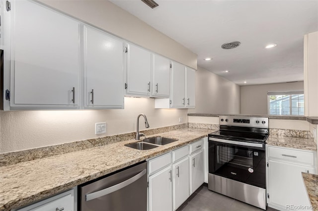 2301 E Fremont Ave Unit W08, Centennial, CO 80122 - kitchen with appliances with stainless steel finishes, white cabinets, tile patterned floors, light stone counters, and recessed lighting