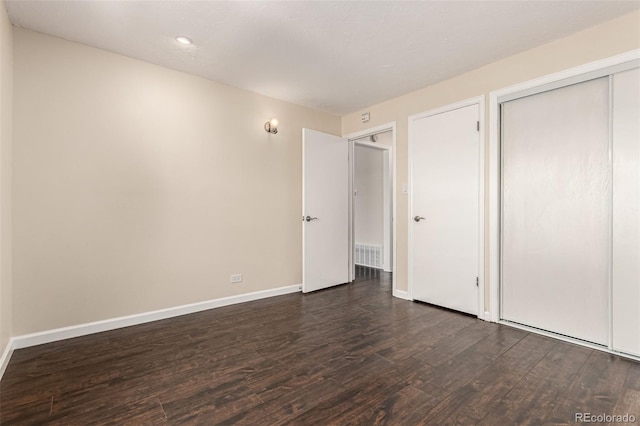 2301 E Fremont Ave Unit W08, Centennial, CO 80122 - unfurnished bedroom with dark wood finished floors, a closet, and recessed lighting