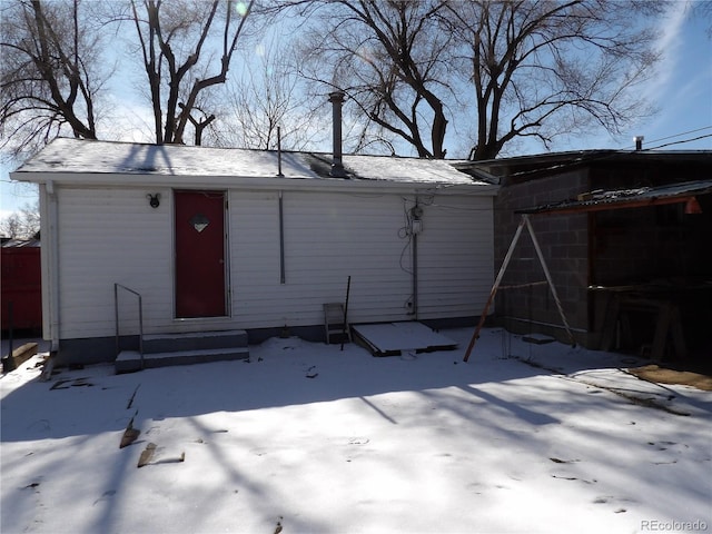 snow covered structure with entry steps