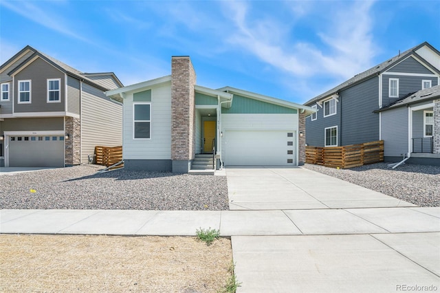 9360 Bahama Ct, Commerce City, CO 80022 - view of front of home with driveway, a chimney, and a garage
