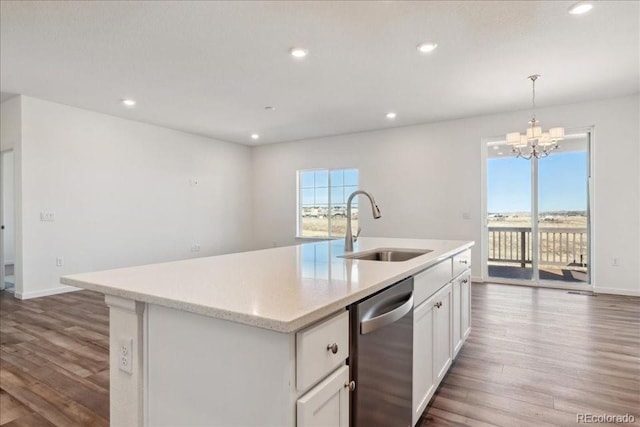 kitchen featuring sink, white cabinetry, stainless steel dishwasher, and a center island with sink