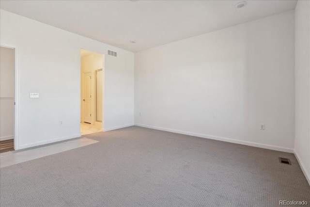 empty room featuring light colored carpet