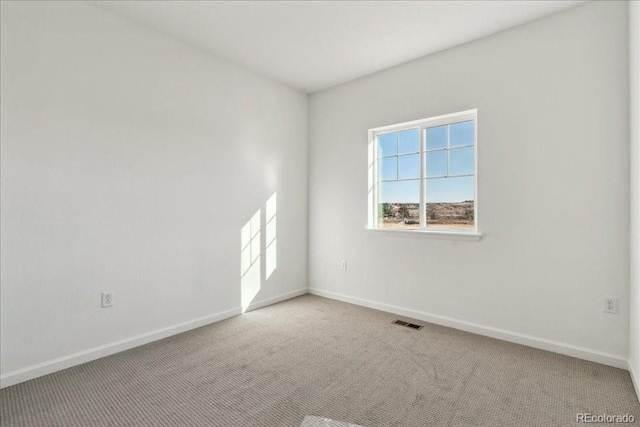 unfurnished room with light colored carpet