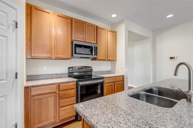 4032 Donnington Cir, Castle Rock, CO 80104 - kitchen featuring stainless steel microwave, electric range, recessed lighting, and light stone countertops