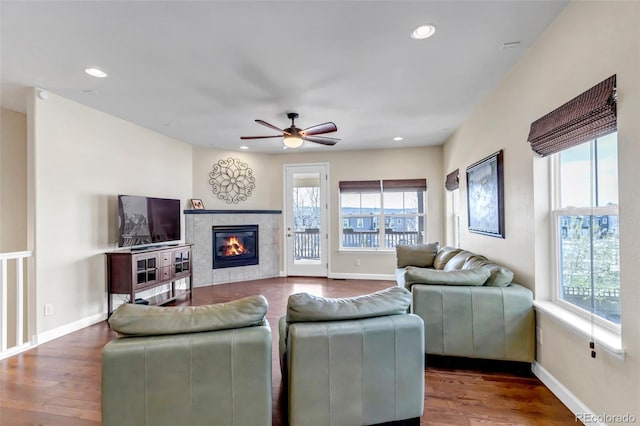 4032 Donnington Cir, Castle Rock, CO 80104 - living room featuring healthy amount of natural light, wood finished floors, a ceiling fan, recessed lighting, and a tile fireplace