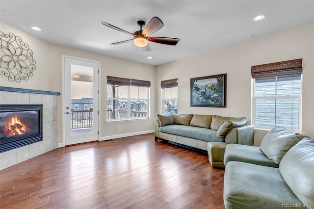 4032 Donnington Cir, Castle Rock, CO 80104 - living area with plenty of natural light, a ceiling fan, a tile fireplace, wood finished floors, and recessed lighting
