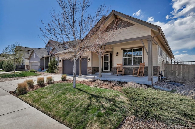 4032 Donnington Cir, Castle Rock, CO 80104 - view of front facade featuring a garage, concrete driveway, stone siding, and covered porch
