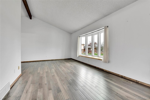 7796 S Marshall Ct, Littleton, CO 80128 - spare room with wood finished floors, a textured ceiling, and baseboards