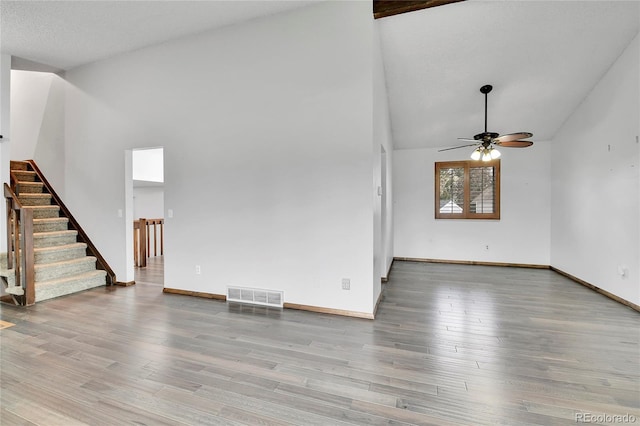 7796 S Marshall Ct, Littleton, CO 80128 - unfurnished living room with a ceiling fan, stairs, wood finished floors, high vaulted ceiling, and baseboards