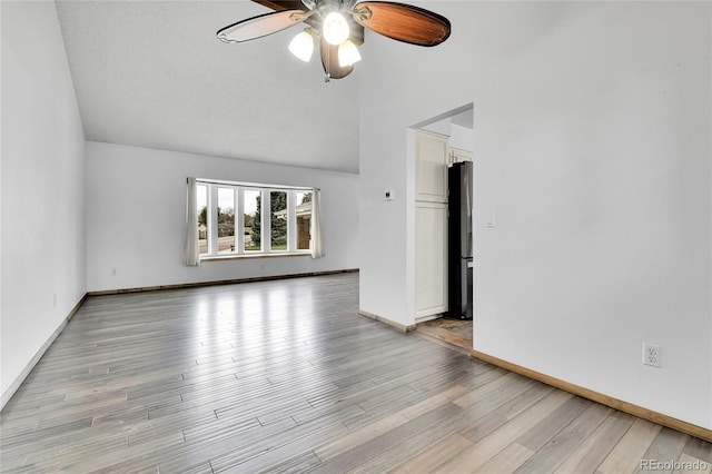 7796 S Marshall Ct, Littleton, CO 80128 - empty room with ceiling fan, light wood finished floors, high vaulted ceiling, and baseboards