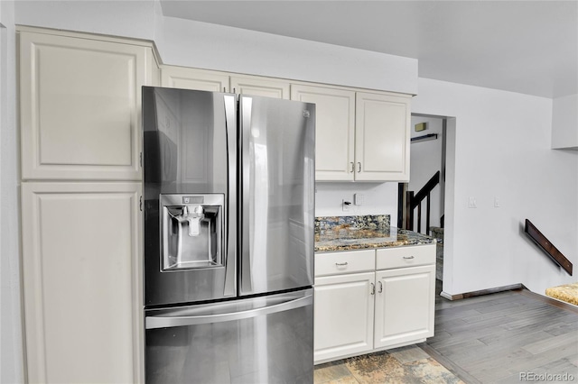 7796 S Marshall Ct, Littleton, CO 80128 - kitchen with stainless steel fridge with ice dispenser, white cabinetry, stone countertops, and baseboards