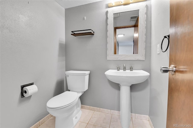 7796 S Marshall Ct, Littleton, CO 80128 - half bath featuring toilet, tile patterned flooring, and baseboards