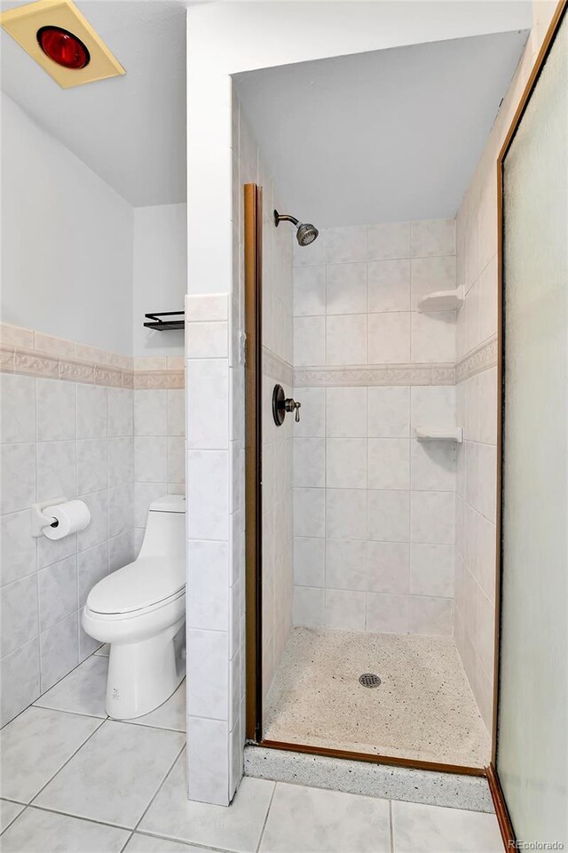 7796 S Marshall Ct, Littleton, CO 80128 - bathroom with tile patterned flooring, a shower stall, toilet, and tile walls