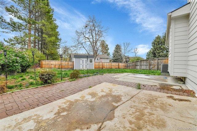 7796 S Marshall Ct, Littleton, CO 80128 - view of patio featuring a shed, a fenced backyard, central air condition unit, and an outdoor structure